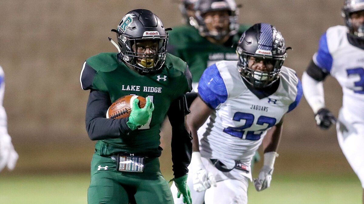 Mansfield Lake Ridge running back Dewone Jackson, left, finds a large hole to run against Mansfield Summit during the first half Friday night at Newsom Stadium. Lake Ridge won 35-24 to clinch a share of the District 7-6A title.