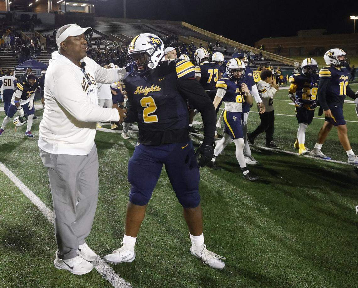 Fort Worth Arlington Heights head coach Curtis James congratulates one of his sons, defensive lineman Carter James (2), after the UIL Class 5A DI area-round football playoff game against Lubbock Monterey Thursday, Nov. 20, 2025, at Shotwell Stadium in Abilene, Texas.