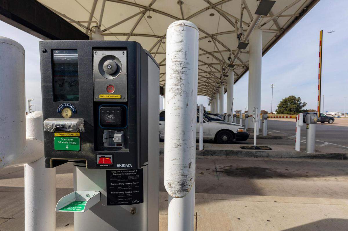 Cars drive through the toll booth at the Dallas Fort Worth International Airport on Friday, Nov. 18, 2022.