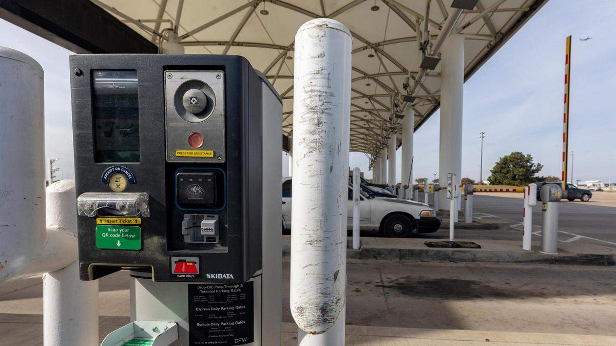 Cars drive through the toll booth at the Dallas Fort Worth International Airport on Friday, Nov. 18, 2022.