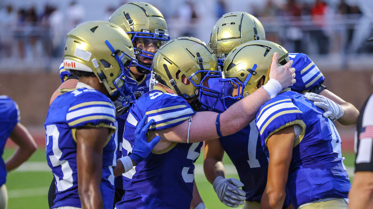 Boswell’s Tyler Reyes (4) celebrates his touchdown with teammates against Saginaw on Sept 5 at Boswell Pioneer Stadium.