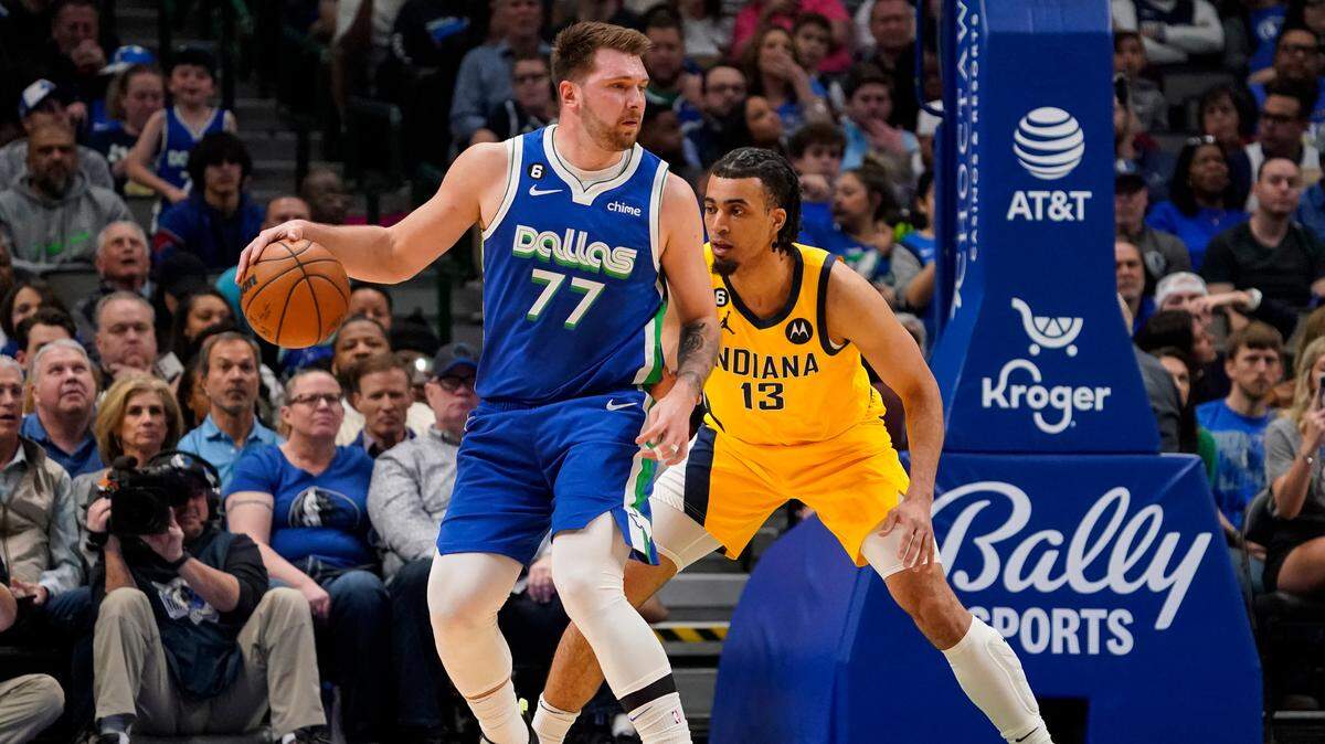Dallas Mavericks guard Luka Doncic (77) controls the ball in front of Indiana Pacers forward Jordan Nwora (13) during their game in Dallas on Tuesday.