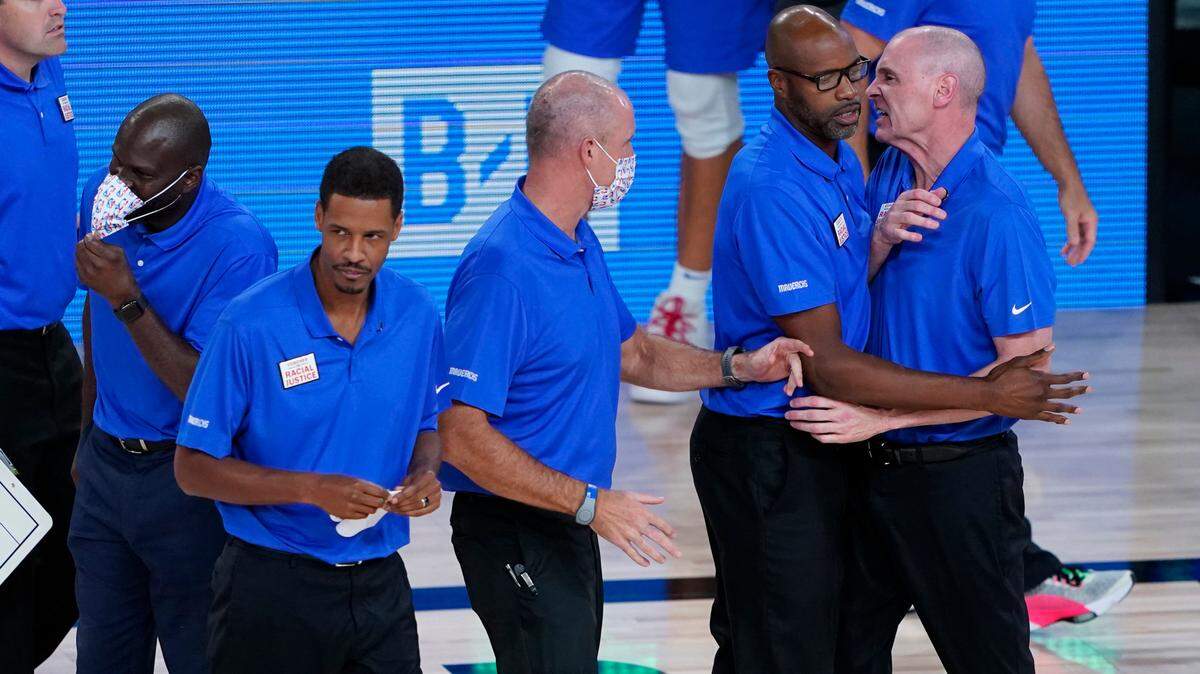 Dallas Mavericks head coach Rick Carlisle, right, is restrained by his coaching staff as he is ejected during the second half of an Tuesday’s playoff game against the Los Angeles Clippers in Lake Buena Vista, Fla.