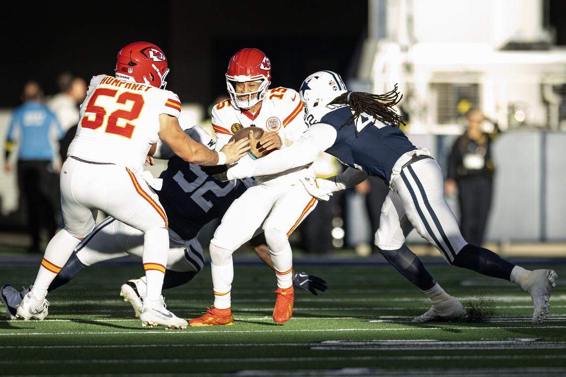 Chiefs quarterback Patrick Mahomes (15) is sacked in the backfield in the first half of an NFL game between the Dallas Cowboys and the Kansas City Chiefs at AT&T Stadium in Arlington on Thursday, Nov. 27, 2025.