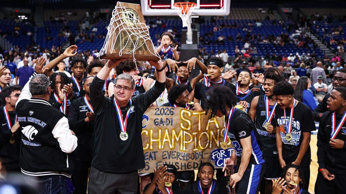 North Crowley head coach Tommy Brakel emotionally hoists the championship trophy after the Class 6A Division I state championship against San Antonio Brennan on Saturday at the Alamodome in San Antonio.