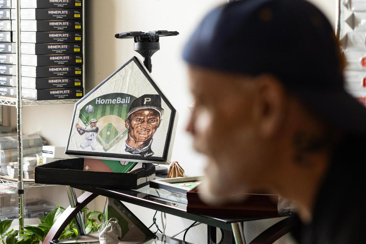 Miguel Otero, the creator of Homeplate USA, keeps the different versions of his game in his apartment including the first version with Hall of Famer Roberto Clemente on the cover in Grapevine on Wednesday, April 16, 2025. Otero invented Homeplate USA, a baseball board game, when he was 11. Now retired at 67, he began producing and selling the game in March out of his apartment.