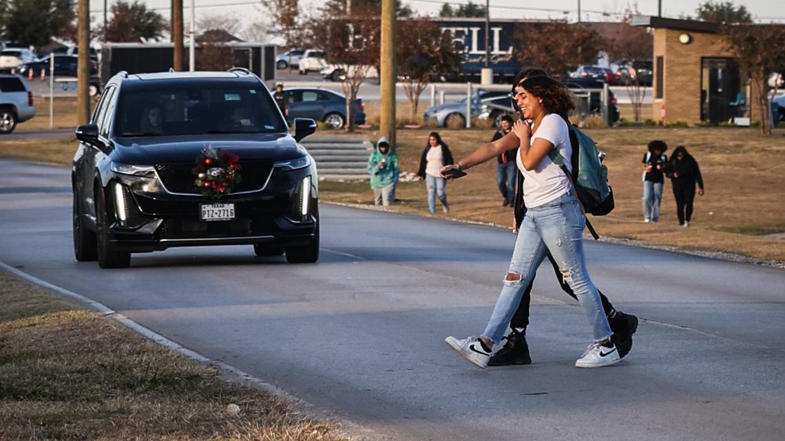 W.E. Boswell High School students cut through traffic on Bailey Boswell Road in 2021. Fort Worth plans to break ground on a $29 million reconstruction of the street next fall, having originally planned to start construction this winter.