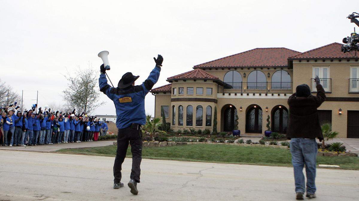 Extreme Makeover: Home Edition assistant director Josh Zilm, gets the crowd to cheer during the taping before the new home was revealed to the Augustin family in 2008.