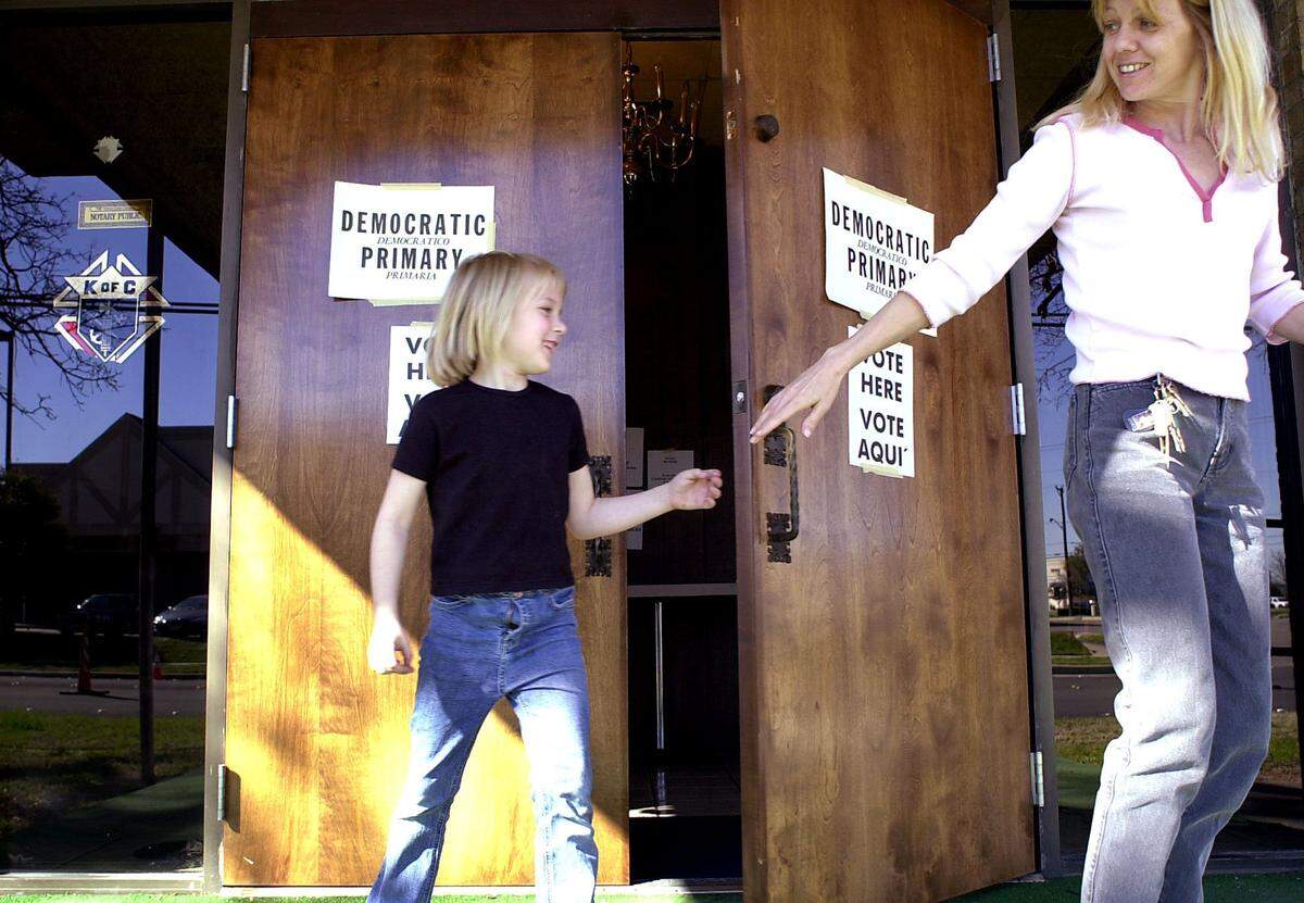 March 9, 2004: Phyllis Marriage leaves the Knights of Columbus on Yuma in Fort Worth with her daughter, Devona, 6, after casting her vote in the primary election.