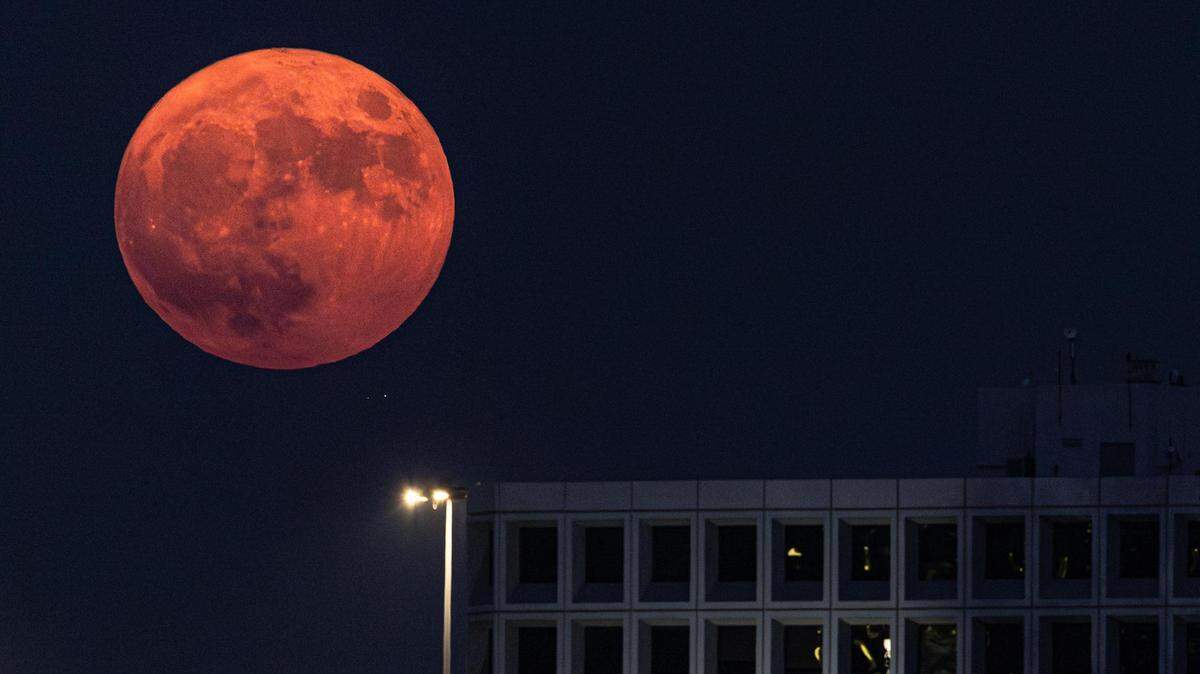 The Super Blue Moon rises over the Summit Office Park Plaza near downtown Fort Worth on Wednesday, Aug. 30, 2023.