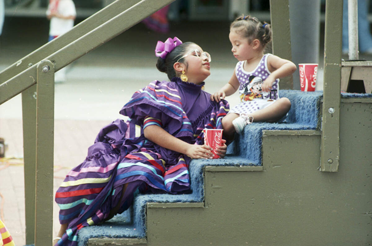 Sept. 10, 1989: Stephanie Longoria takes a break from performing with the Ballet Follorico to check out her niece, Amber Weaver, 3, at the main stage in the 11th annual Fiesta in the Park. The fiesta was held downtown to benefit the Fort Worth Mexican American College Education Fund. Arts and crafts were part of the celebration.