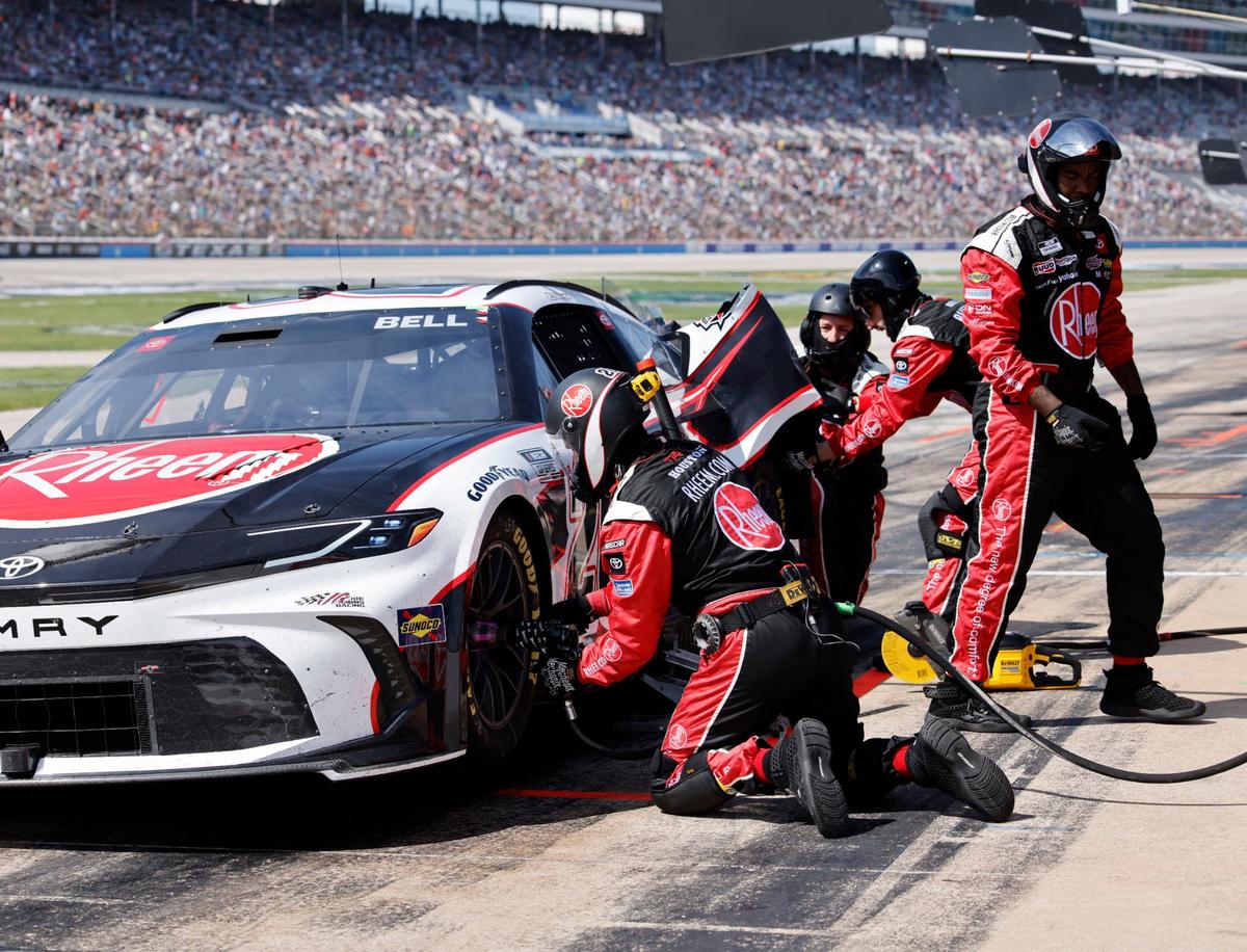 The pit crew of Christopher Bell (20) works on his Toyota after he smacked the wall coming out of turn four during the Auto Trader Echo Park 400 at Texas Motor Speedway in Fort Worth, Texas, April 14, 2024. Kyle Larson won stage 1. (Special to the Star-Telegram/Bob Booth)