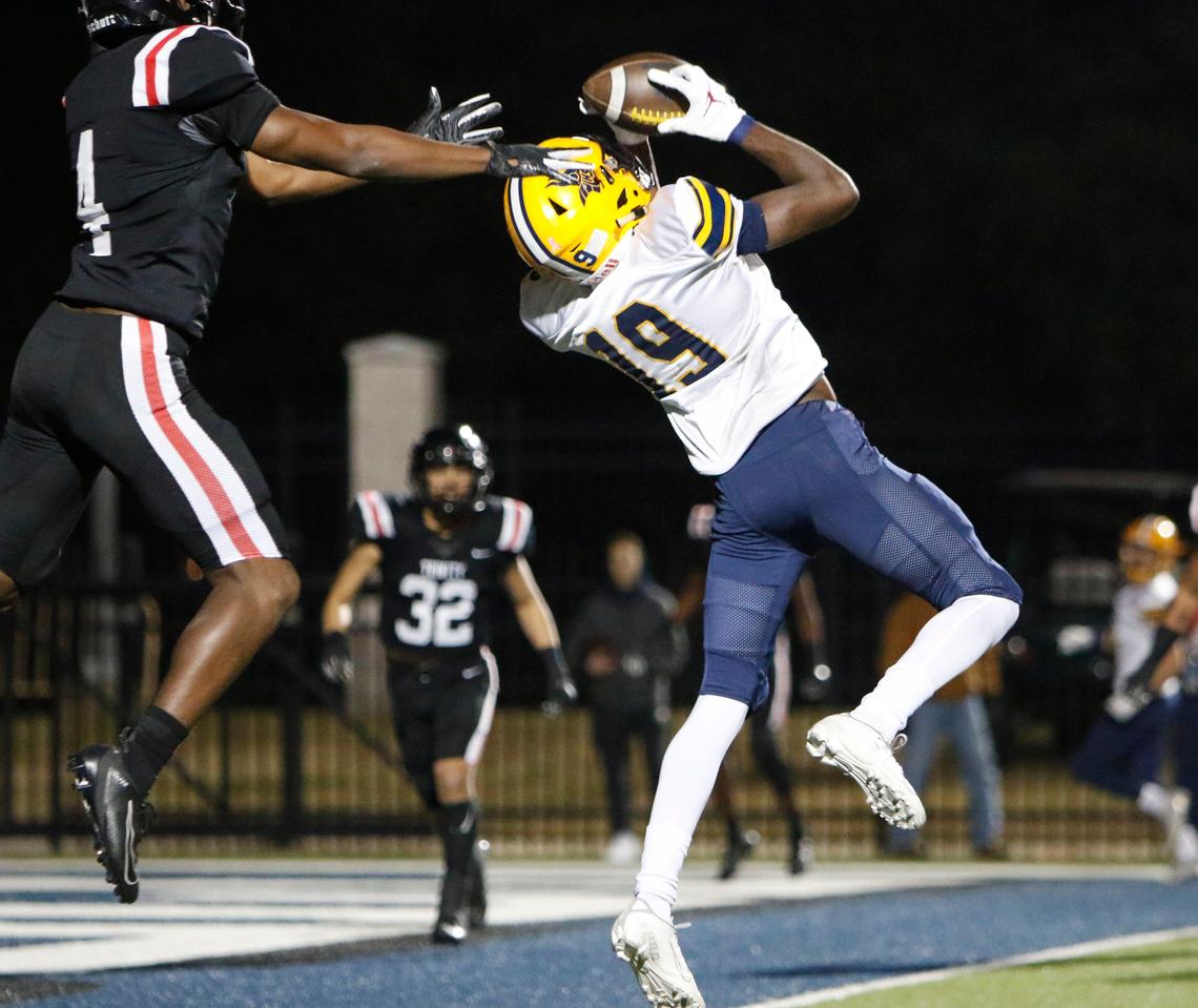Lamar wide receiver Trevon West (19) pulls down a touchdown pass in the second quarter, defended by Trinity defensive back John Shead (4). The Lamar Vikings played the Trinity Trojans at Pennington Field in Bedford Friday, November 15, 2019.