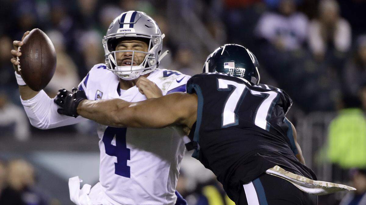 Dallas Cowboys quarterback Dak Prescott (4) is sacked by Philadelphia Eagles defensive end Michael Bennett (77) during the second half of an NFL football game, Sunday, Nov. 11, 2018, in Philadelphia.