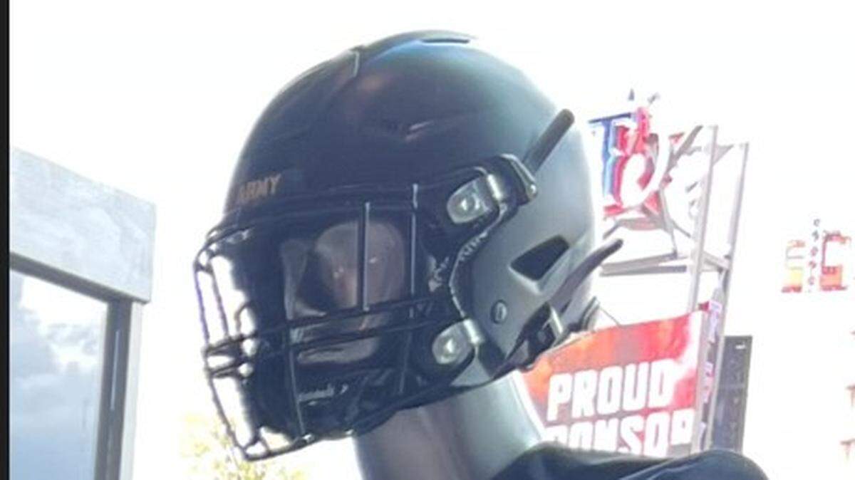 A football helmet with the word Army on the front is displayed on a mannequin's head.