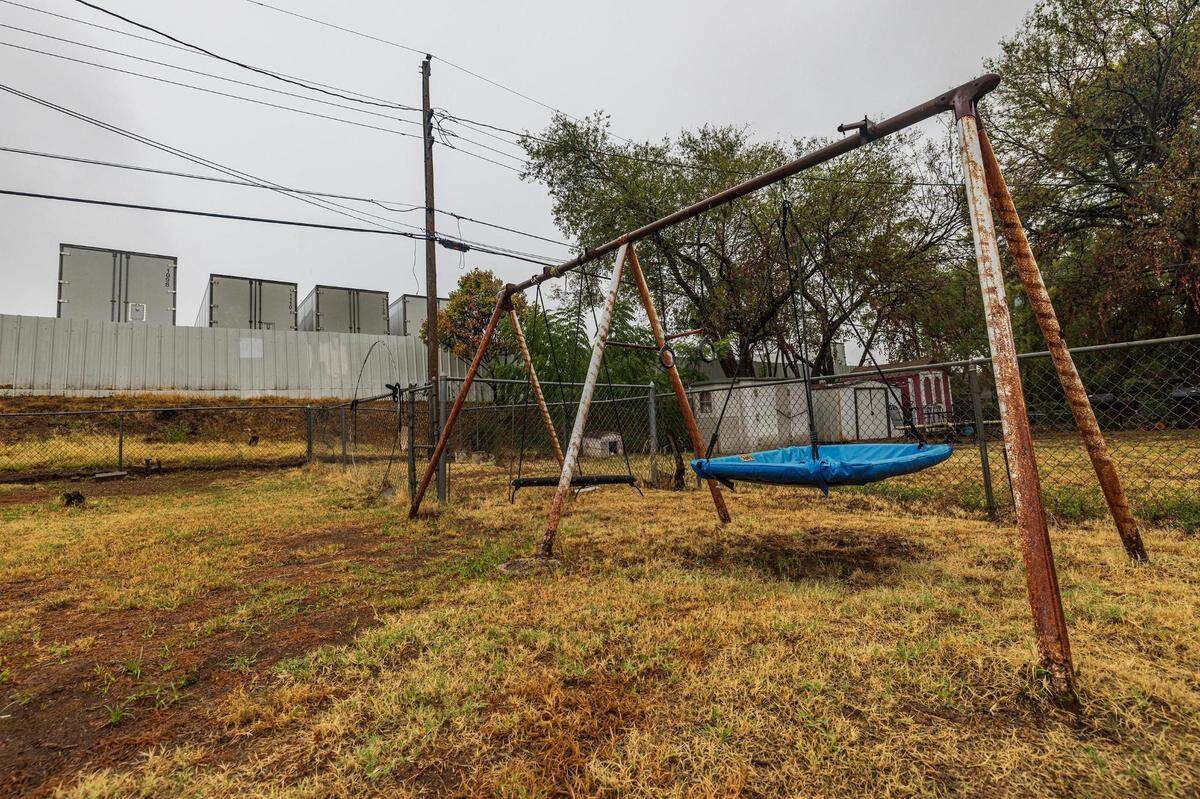 Multiple semi-trailers are parked adjacent to the backyard of Echo Heights resident Letitia Wilbourn. Wilbourn says the trucking company has contributed to air and noise pollution in her neighborhood.