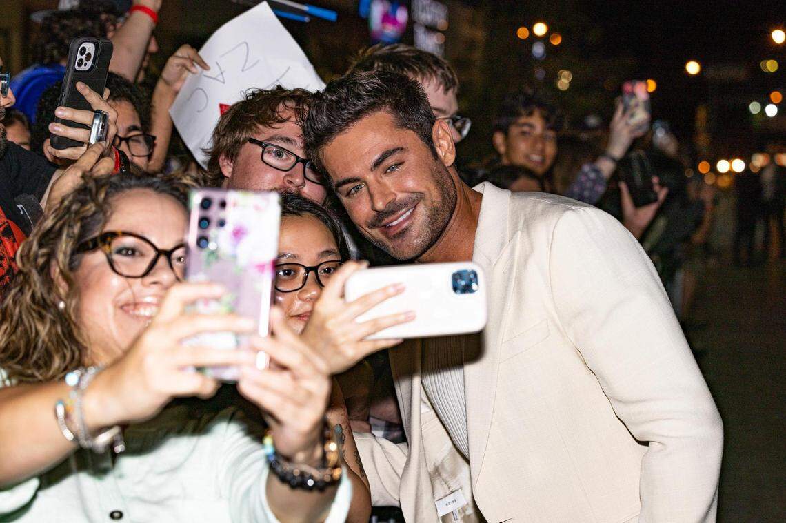 Actor Zac Efron, who stars as Kevin Von Erich, poses for photos with fans upon arrival for the world premiere of the movie “The Iron Claw,” at the Texas Theater in Dallas on Wednesday, Nov. 8, 2023.