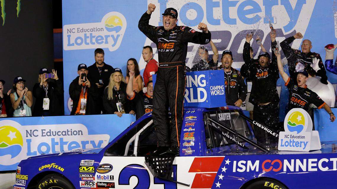 Johnny Sauter celebrates in Victory Lane after winning the NASCAR Truck Series auto race at Charlotte Motor Speedway, Friday, May 18, 2018, in Concord, N.C.