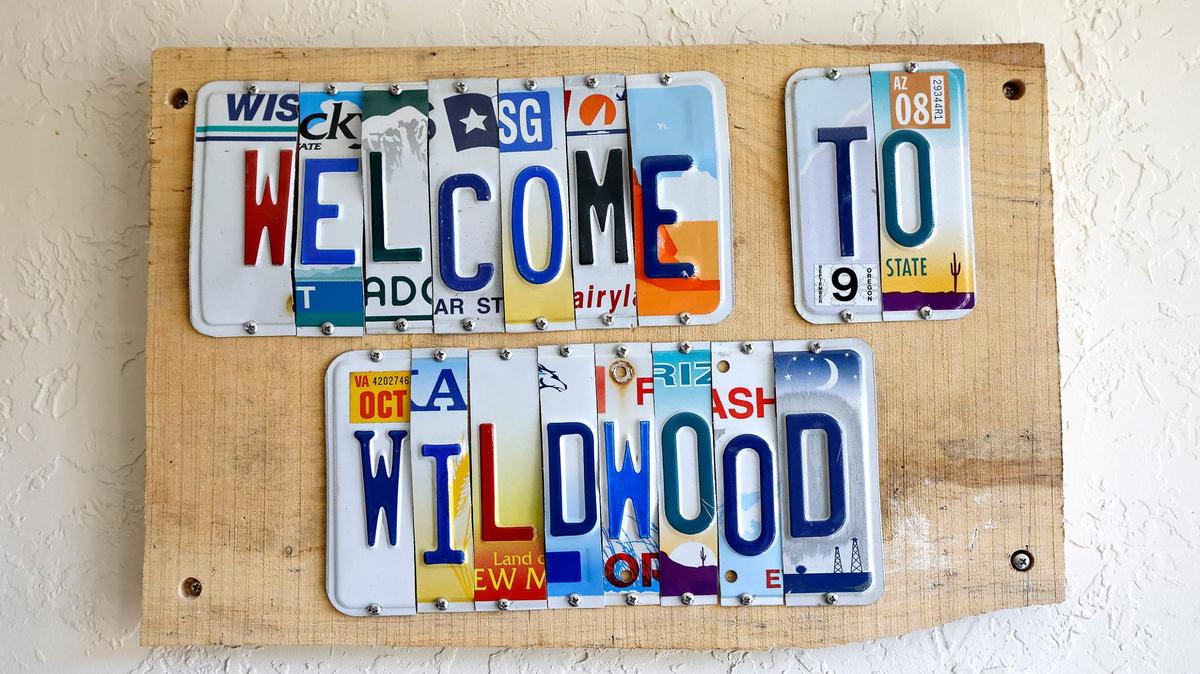 A sign greets guests and members to Wildwood Naturist’s Resort’s main office on Friday, May 17, 2024, in Decatur. Wildwood is a nudist facility where guests and members can enjoy various amenities, like two swimming pools and wilderness trails, on 98 acres of land in North Texas.