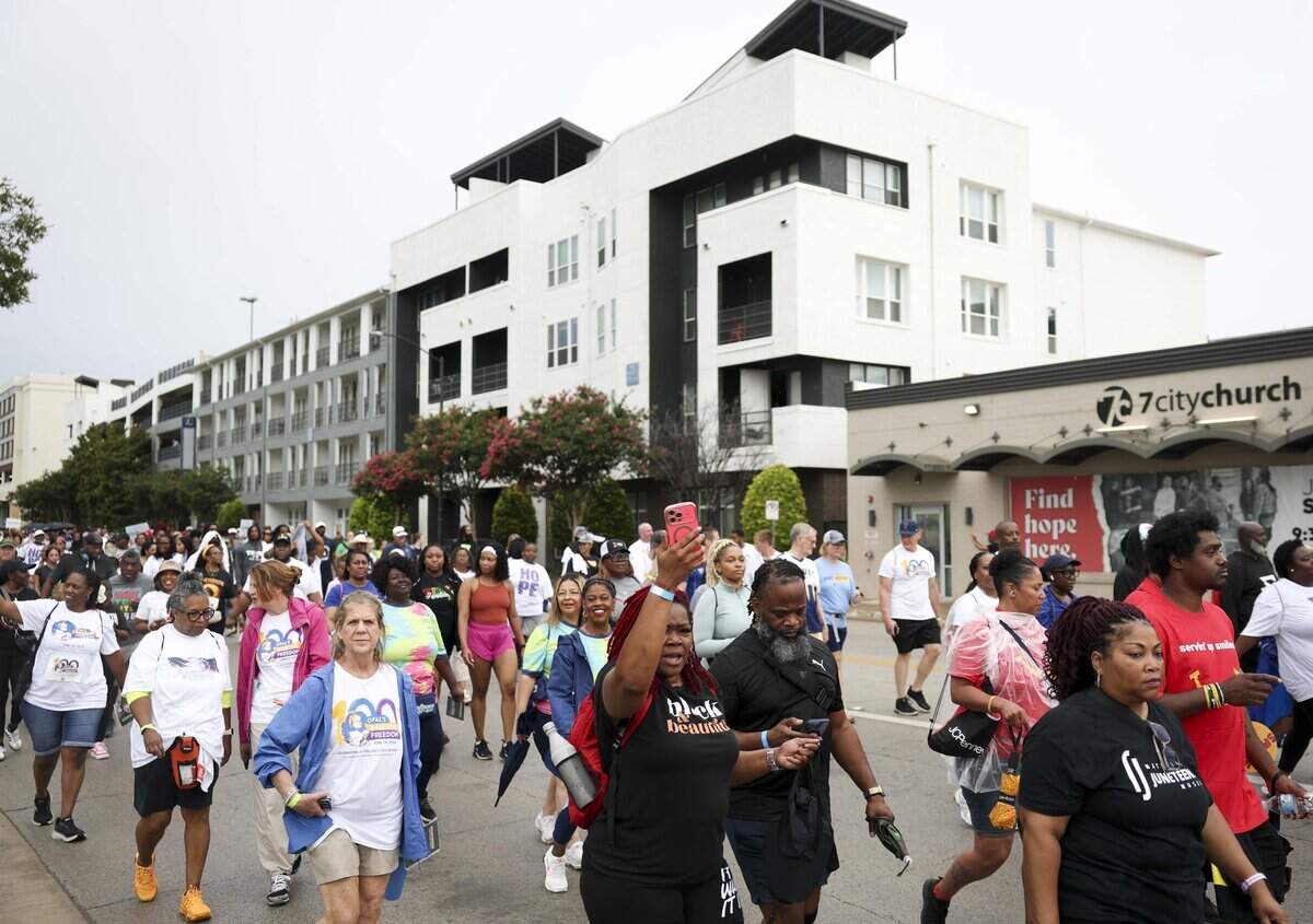 People walk down West Lancaster Avenue for the Opal Lee Walk for Freedom on Friday, June 19, 2026, in Fort Worth. The walk, which started in 2016, was held to lobby for making Juneteenth a recognized national holiday.