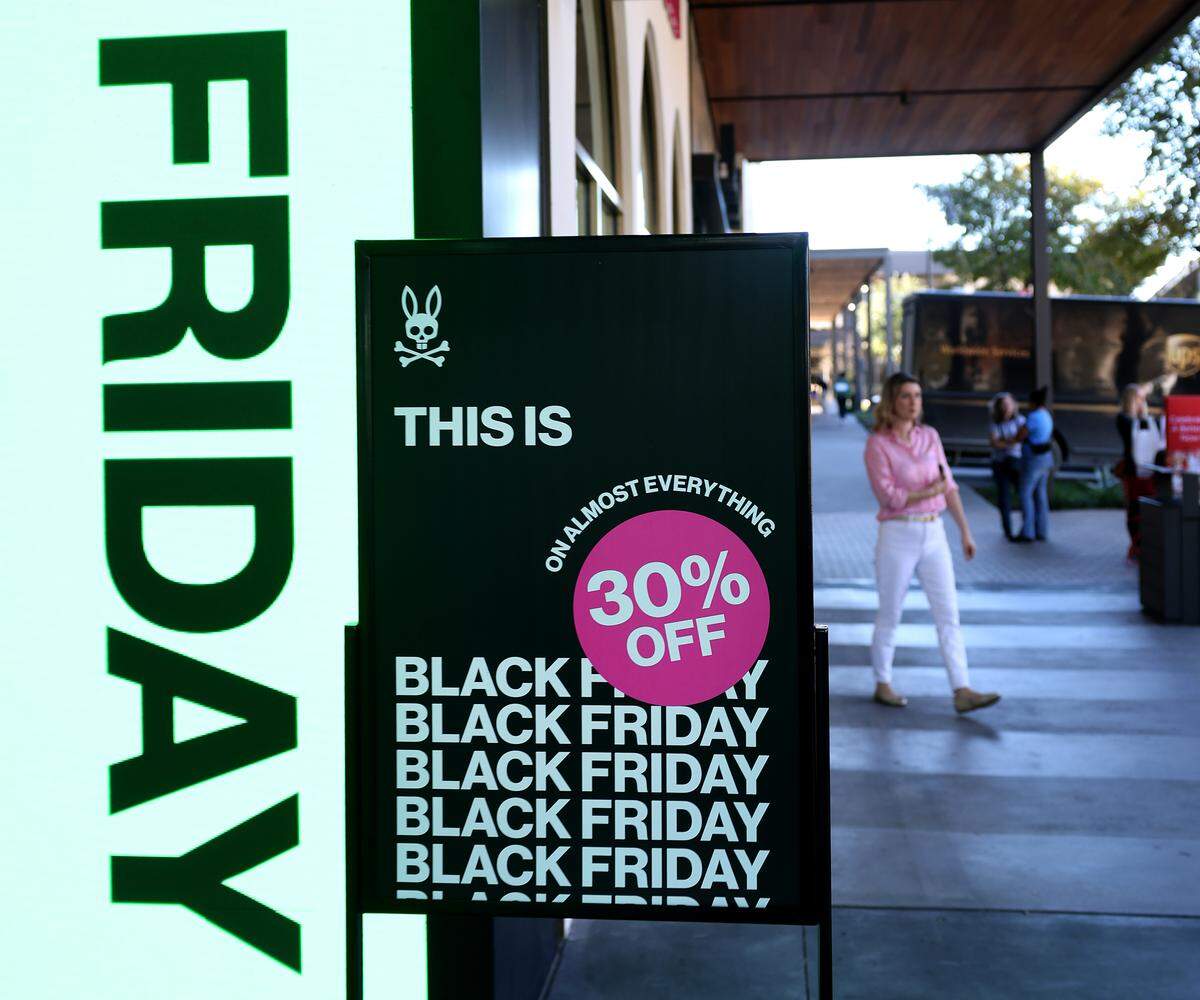 Signs advertise holiday season sales at The Shops at Clearfork on Tuesday, Nov. 25, 2025, in Fort Worth.