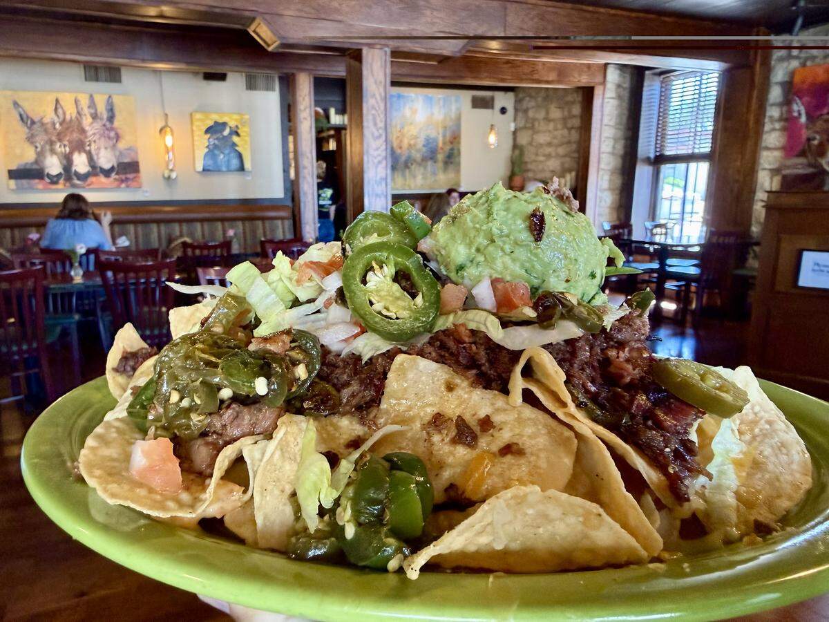 Nachos are topped with brisket, queso, guacamole and jalapenos at Shaw’s Southwest Grille in Granbury, Texas.