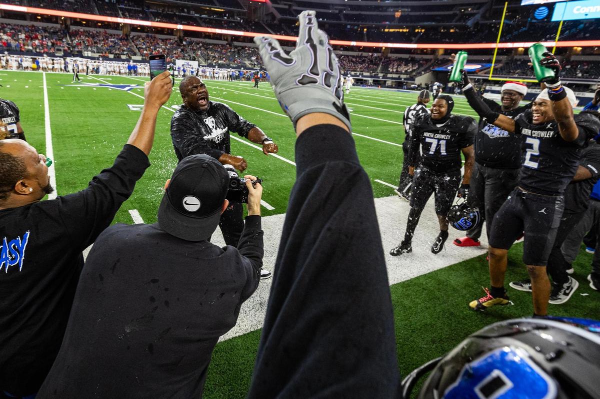 North Crowley Head Coach Ray Gates gets water poured on him after winning the UIL 6A Division I state championship game against Austin Westlake at AT&T Stadium in Arlington on Saturday, Dec. 21, 2024.