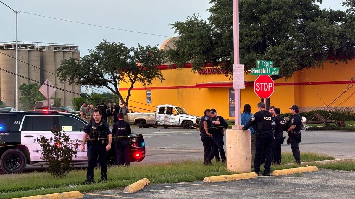 Police officers and firefighters at the scene where injuries were reported following a vehicle crash during a police pursuit on Hemphill Street in south Fort Worth on Monday night, May 6, 2024.