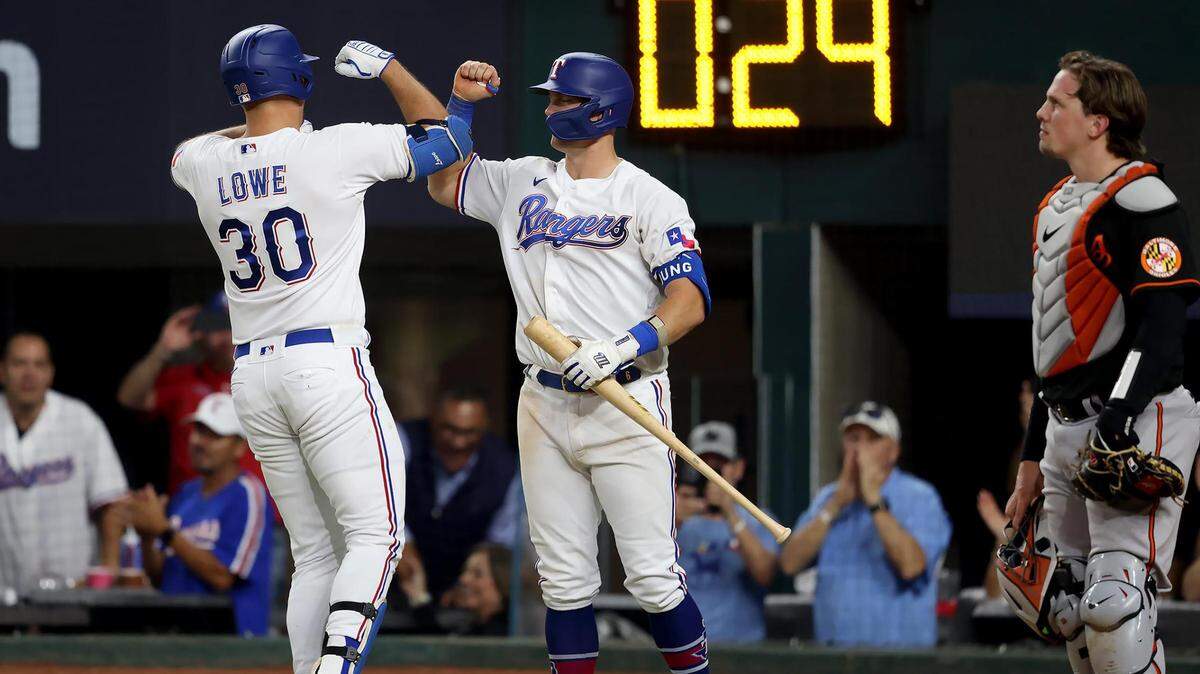 Texas Rangers first baseman Nathaniel Lowe, left, celebrates with teammate Josh Jung after hitting a home run in the sixth inning in Game 3 of the ALDS against the Baltimore Orioles on Tuesday, October 10, 2023, at Globe Life Field in Arlington.