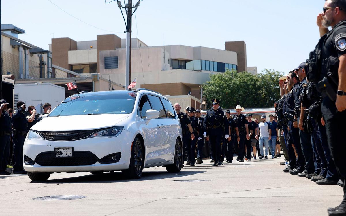 Law enforcement, city officials, medical staff, family and friends line up along St. Louis Avenue as the body of Fort Worth Police Department Sgt. Billy Randolph’s body is escorted from John Peter Smith Hospital to the medical examiner’s office on Monday, Aug. 12, 2024, in Fort Worth. Randolph was killed earlier in the morning after being hit by a vehicle while working at an accident scene on I-35W.