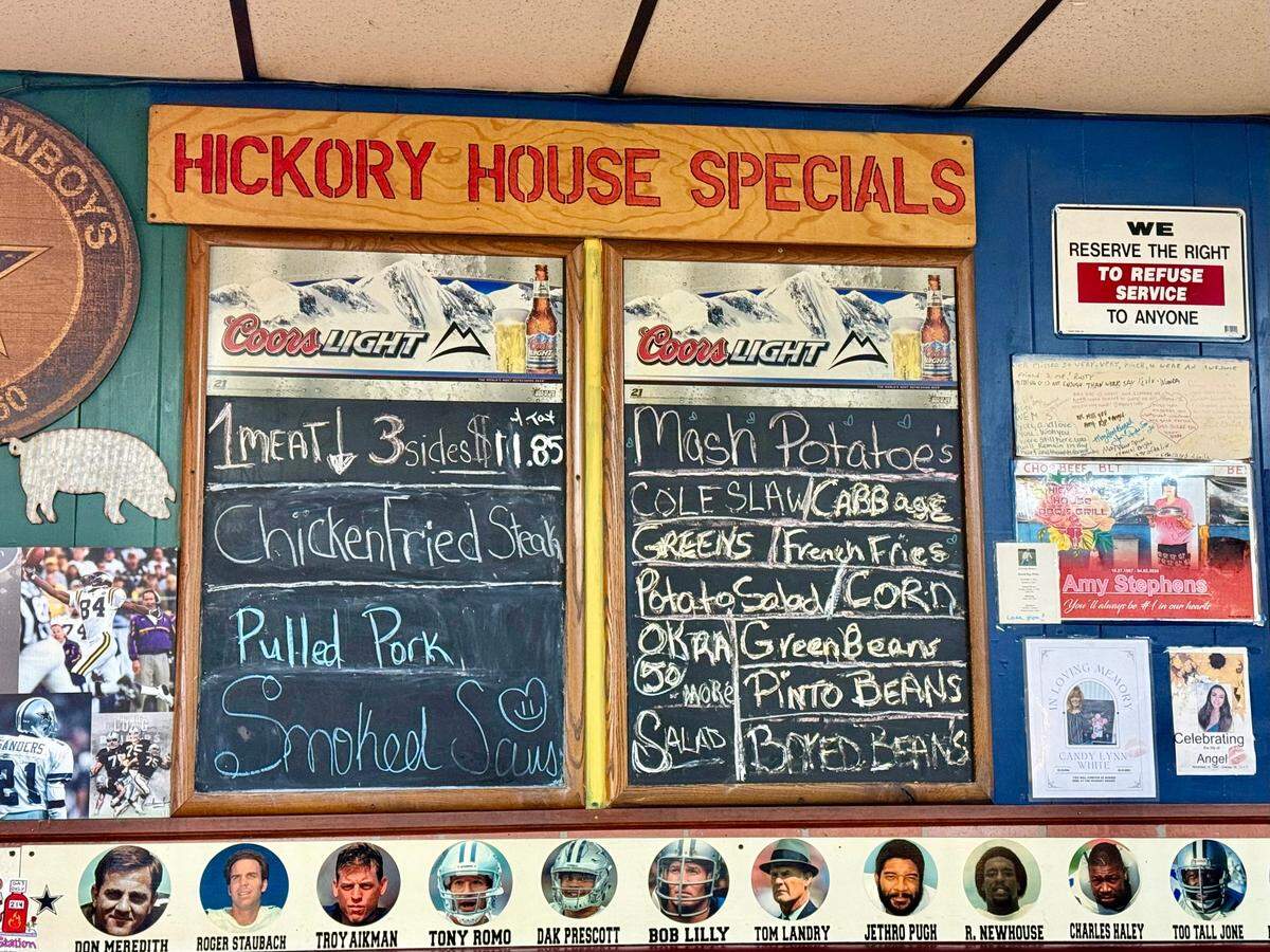 The specials board at Hickory House BBQ and Grill offers inexpensive plate lunches with photos of Dallas Cowboys heroes beneath.