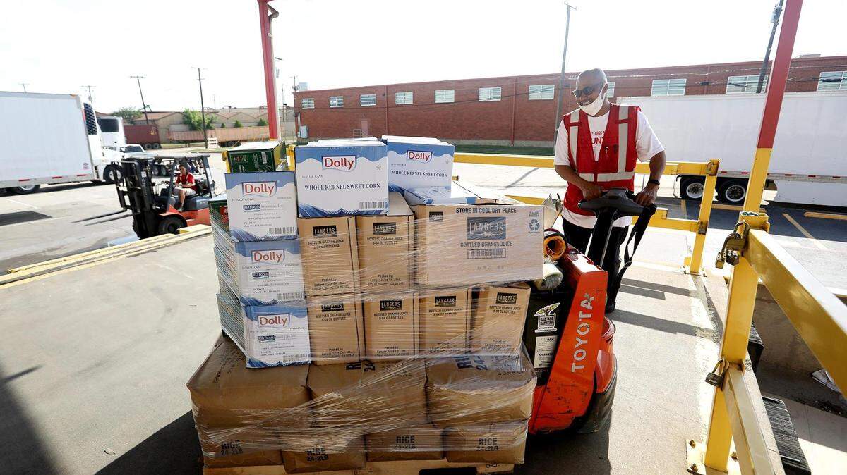 Tarrant Area Food Bank employee Michael Kelly brings out a pallet of food while working to load distribution trucks on Thursday, May 27, 2021, in Fort Worth.
