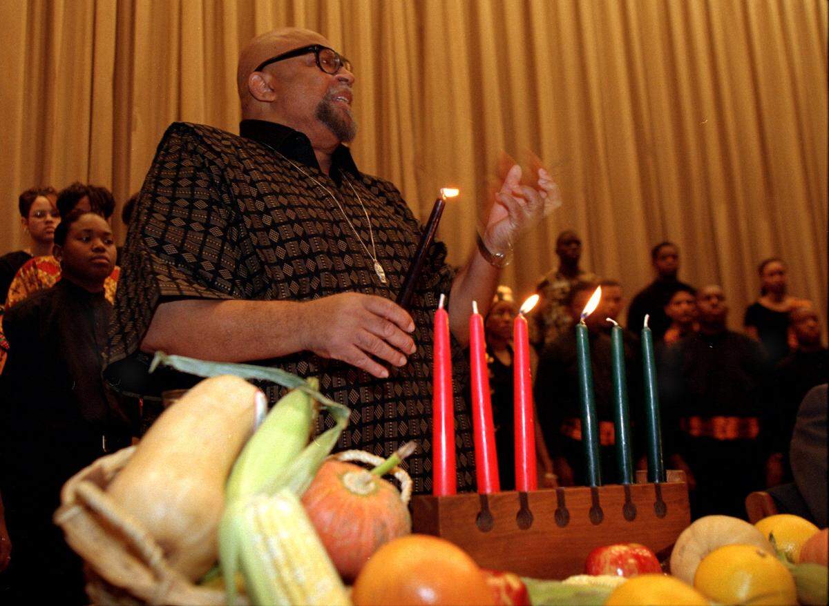 Dr. Maulana Karenga speaks about the celebration of Kwanzaa to O.D. Wyatt High School students Friday before the unveiling of the U.S. Postage stamp commemorating the holiday. Dr. Karenga created the African-American holiday, Kwanzaa.