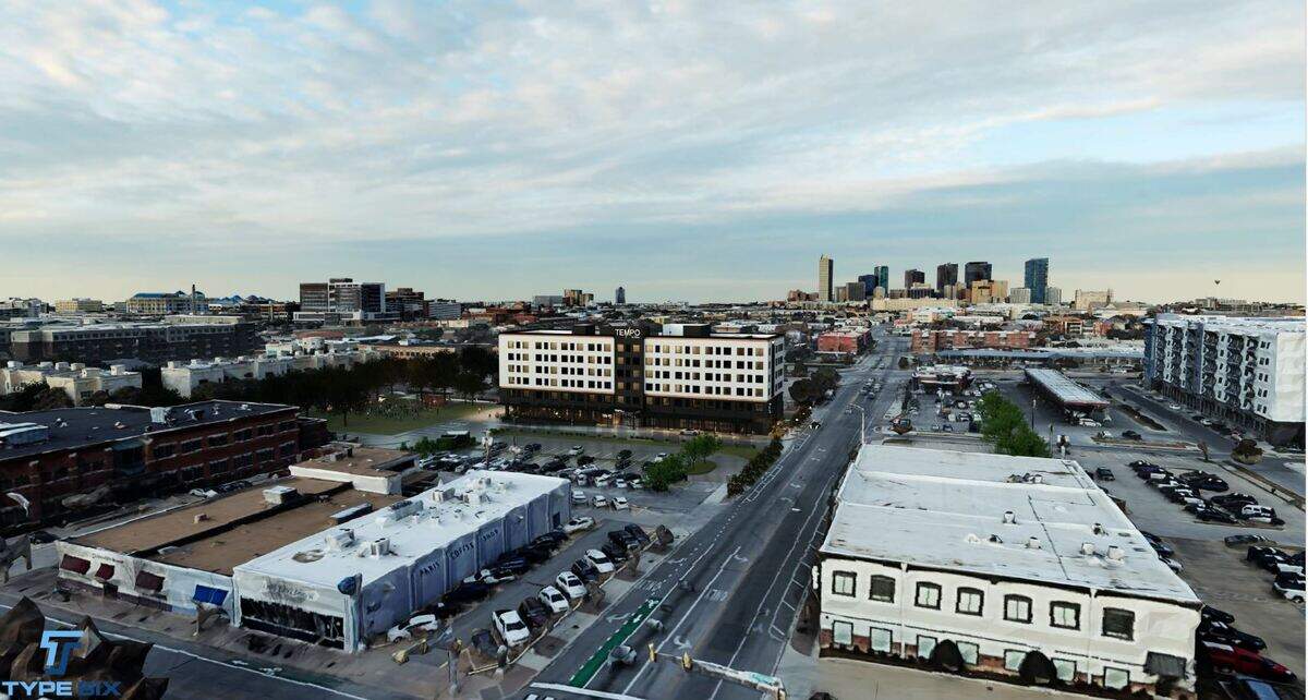 A rendering of a new six-story Tempo hotel by Hilton proposed at 1200 Hemphill St., between West Magnolia Avenue and West Rosedale Street, next to Magnolia Green Park. This view, looking north, shows the Paris Coffee Shop in the foreground and the Fort Worth skyline in the distance.