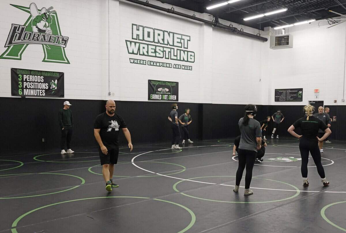 Five girls and five boys with their two alternates on the Azle wrestling team work out during one of the final practices before the state championship meet at Azle High School in Azle, Texas, on Friday, Feb. 9, 2026.