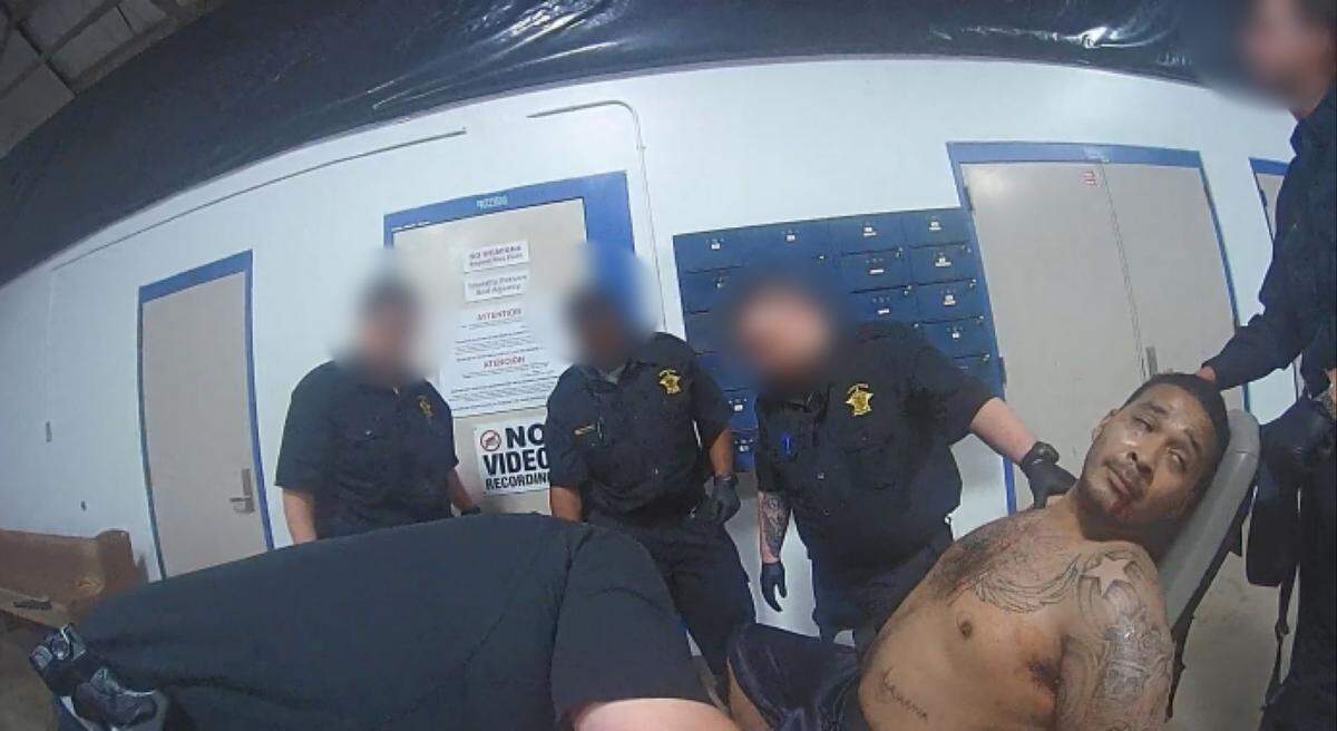 This image taken from an officer’s body camera footage shows Smallwood being strapped to the restraint chair, according to the lawsuit. The image is one four photos included in the complaint.