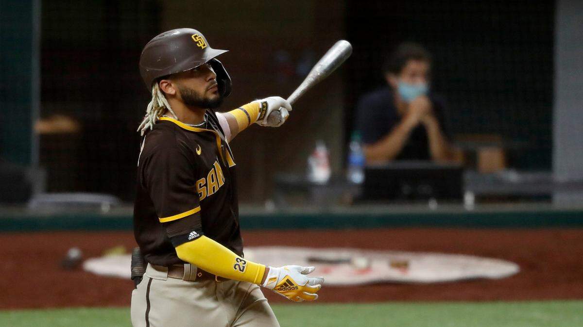 San Diego Padres’ Fernando Tatis Jr. watches the flight of his grand slam ball that came off a pitch from Texas Rangers relief pitcher Juan Nicasio in the eighth inning of a baseball game in Arlington, Texas, Monday Aug. 17, 2020. The shot also scored Jurickson Profar, Josh Naylor and Trent Grisham. (AP Photo/Tony Gutierrez)