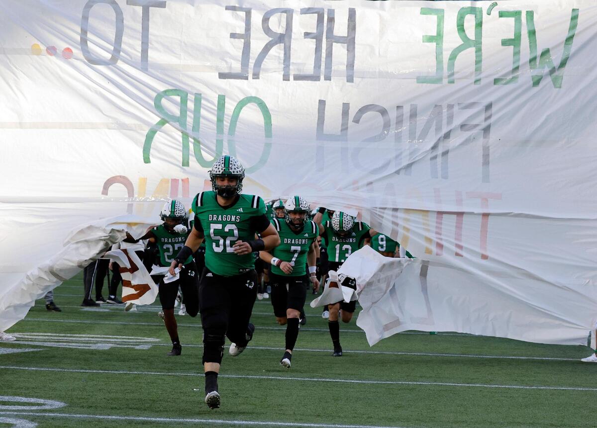 The Dragons take the field for the first half of a UIL Conference 6A Division 2 region football playoff game at Choctaw Stadium in Arlington, Texas, Friday, Nov. 24, 2023.