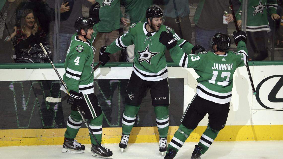 Dallas Stars defenseman Miro Heiskanen (4) and center Mattias Janmark (13) celebrate the game winning goal by Jason Dickinson (16) in overtime against the Boston Bruins on Friday in Dallas.