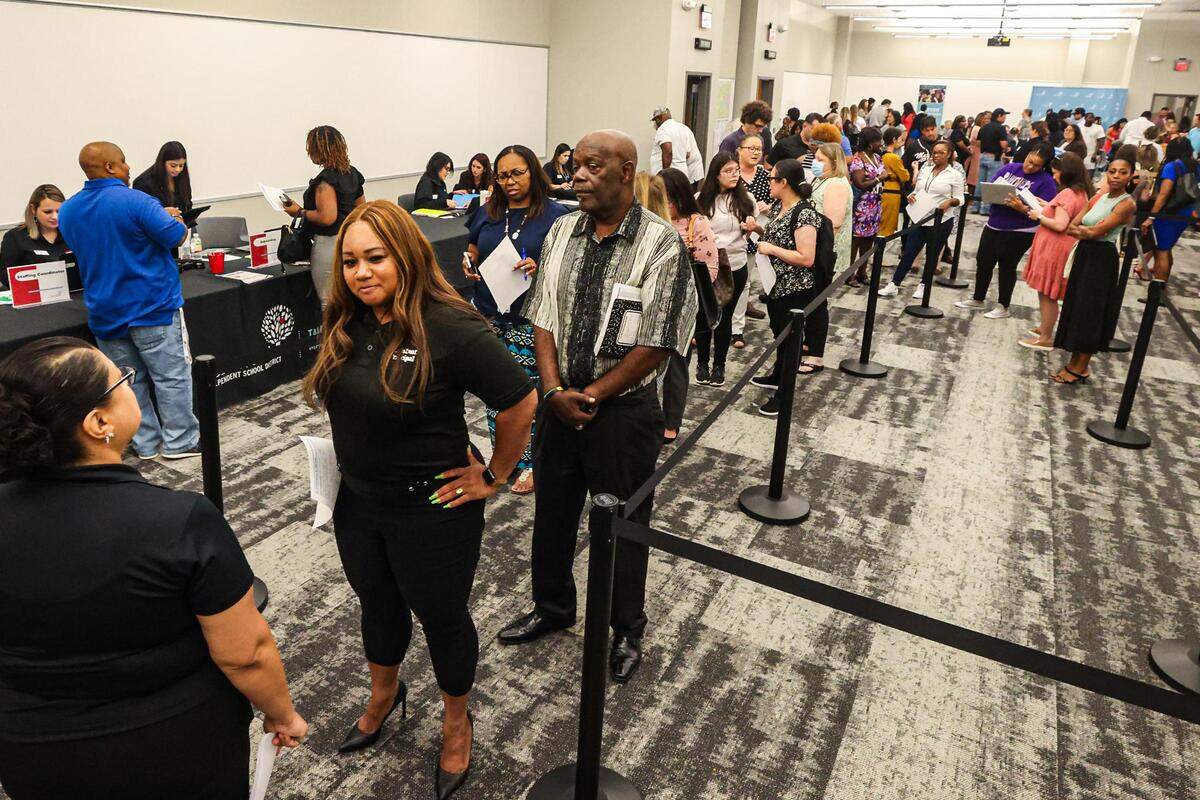 Prospective teaching candidates line up to speak with district coordinators regarding a position for the Fort Worth Independent School District-wide teacher hiring fair at the FWISD Teaching and Learning Center on Thursday, July 27, 2023.