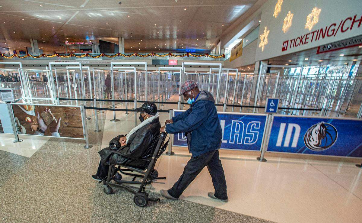 John Quicny Jones pushes a passenger to her gate Wednesday, Dec. 28, 2022. Jones said the difference between earlier in the week and Wednesday was, “Like night and Day.”
