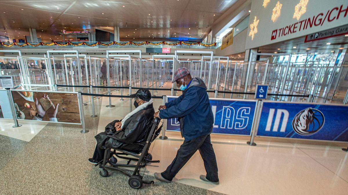 John Quicny Jones pushes a passenger to her gate Wednesday, Dec. 28, 2022,. Jones said the difference between earlier in the week and Wednesday was, “Like night and Day.”