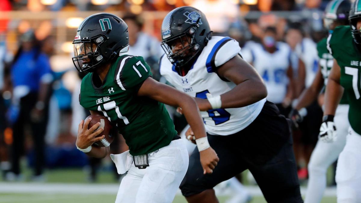 Lake Ridge quarterback Kennen Miller outruns the Summit defense. Lake Ridge won 50-27.