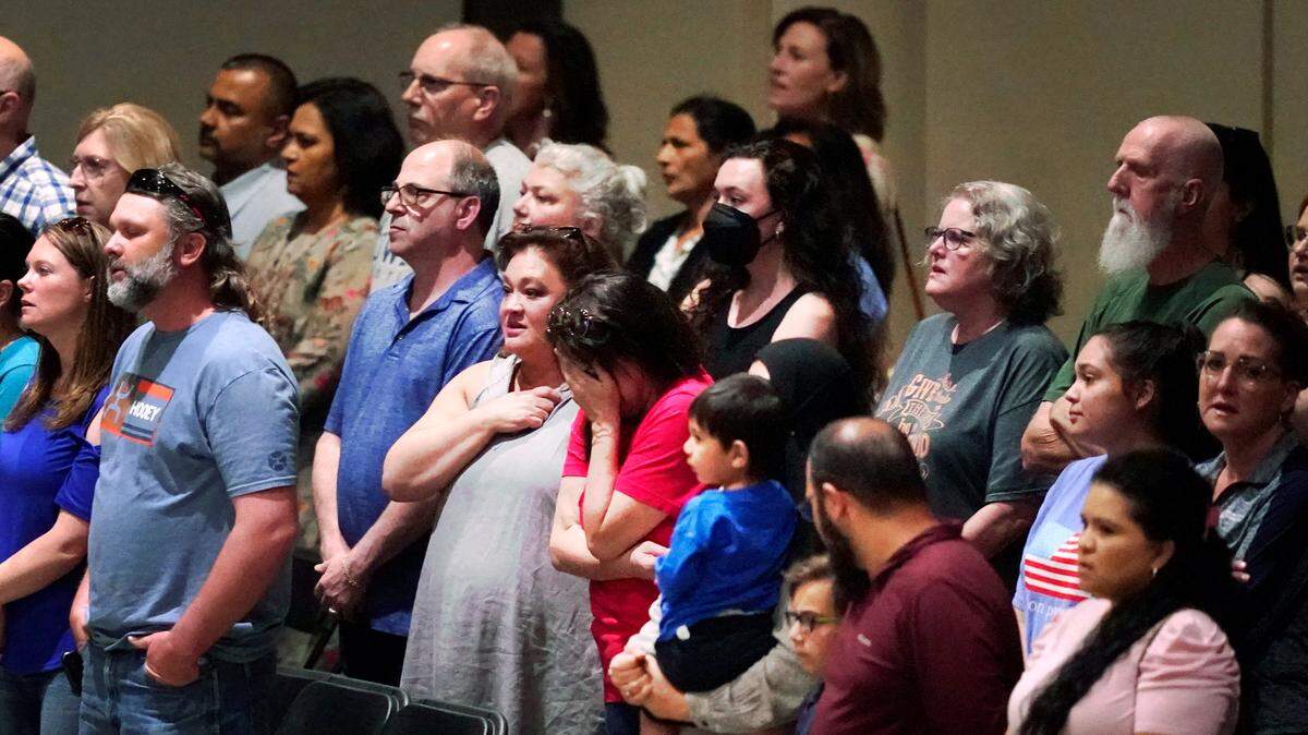 People gathered for a prayer vigil Sunday in Allen, a day after a gunman killed eight at an outlet mall.
