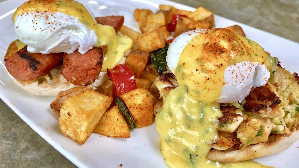 An andouille Benedict, left, and a king crab Benedict are on the brunch menu at Waters Restaurant.