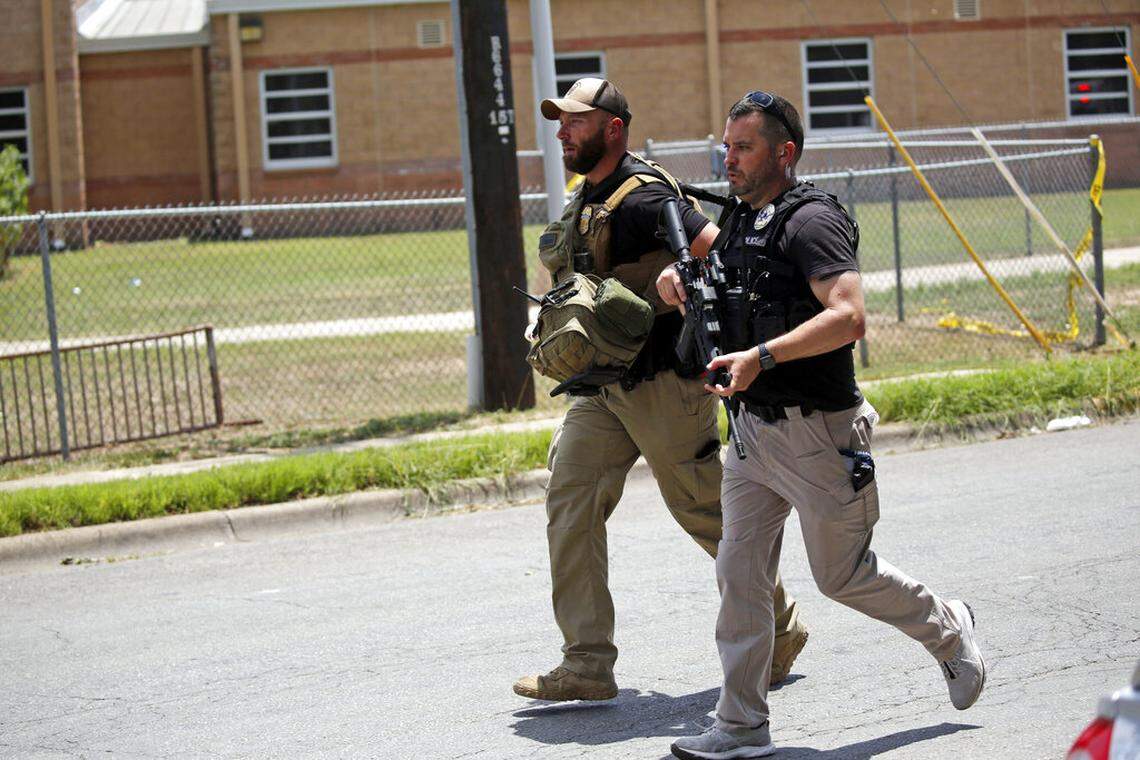 Police walk near Robb Elementary School following a shooting, Tuesday, May 24, 2022, in Uvalde, Texas. (AP Photo/Dario Lopez-Mills)