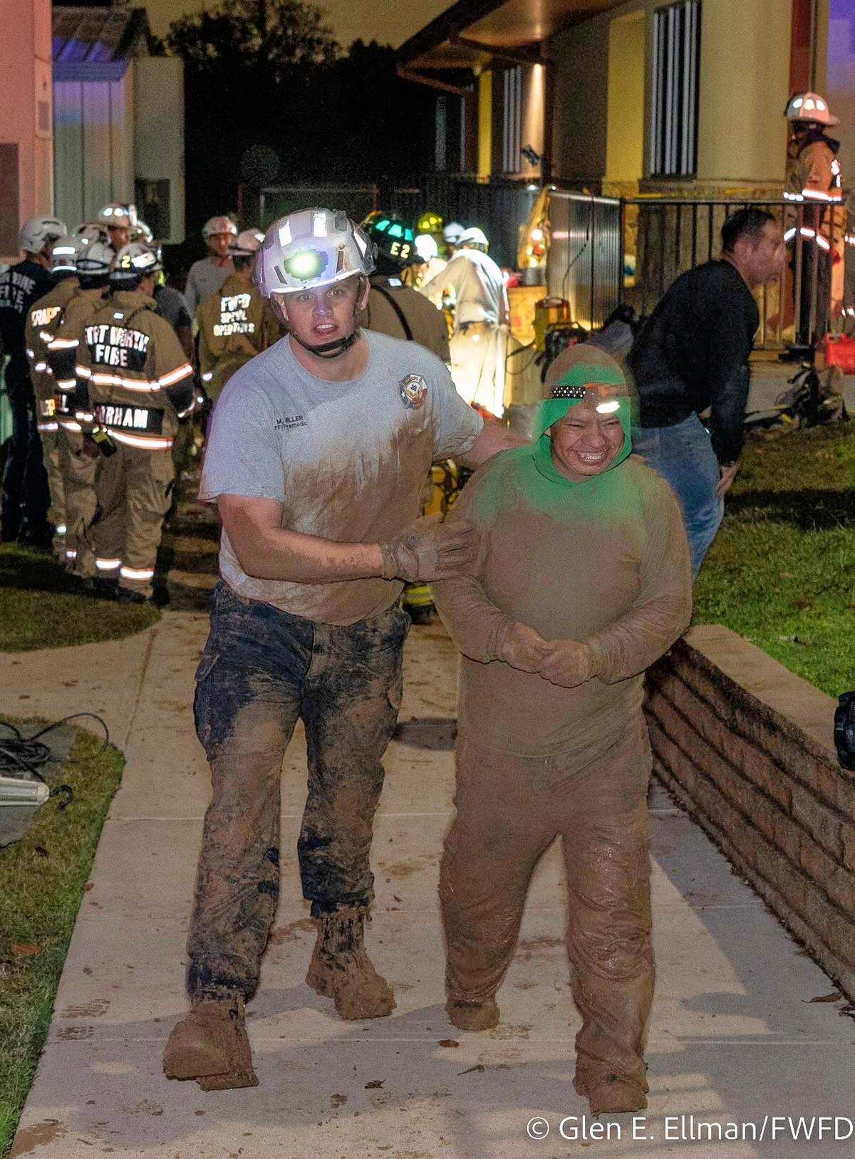 Two workers who were trapped for more than an hour Monday night while trying to fix a leak under Treetops School International in Euless were rescued by firefighters.
