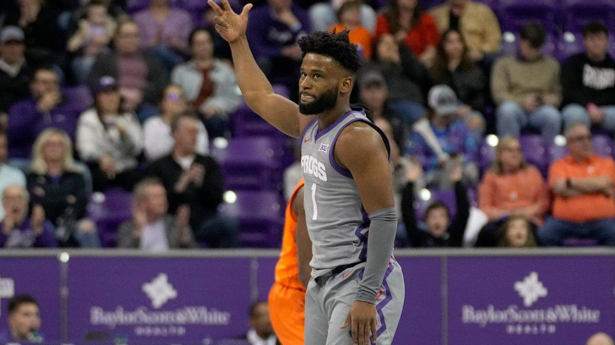 TCU guard Mike Miles Jr. (1) celebrates sinking a three-point shot against Oklahoma State on Saturday.