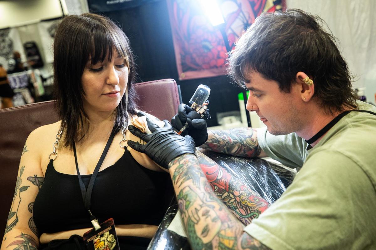 Jackie Provenzano, left, gets a tattoo from Chance Wallace, right, during Fort Worth Tattoo Arts Festival on Friday, June 7, 2024, at the Fort Worth Convention Center. Provenzano heard of Wallace on Instagram and met up at the event.