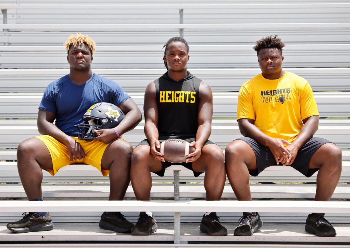 Arlington Heights head football coach Curtis James’ sons Yellow Jacket players defensive end Caynan, running back Carson and defensive end Carter at the schools football field in Fort Worth, Texas, Thursday July 17, 2025.